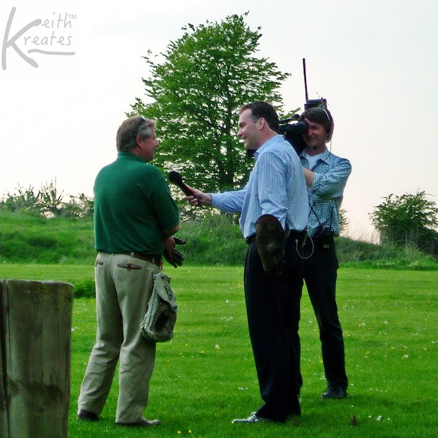 Photo of TV reporters interviewing a guy